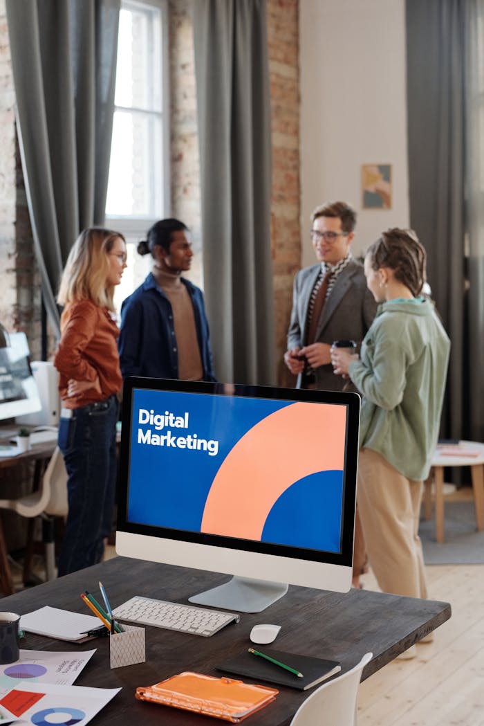 Business team engaged in a digital marketing discussion in a modern office setting.